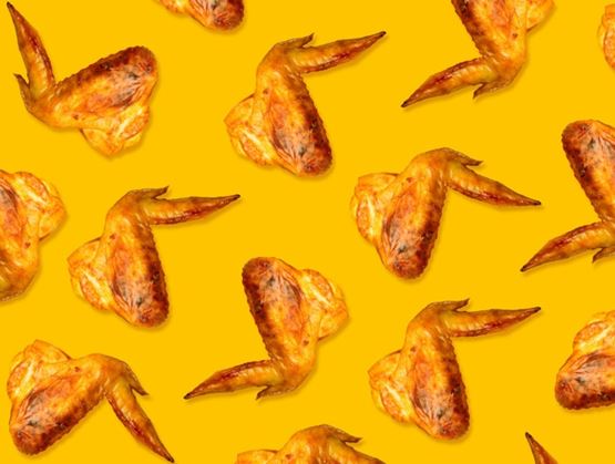 Repeating pattern of grilled chicken wings arranged on a bright yellow background, creating a colorful and appetizing visual.