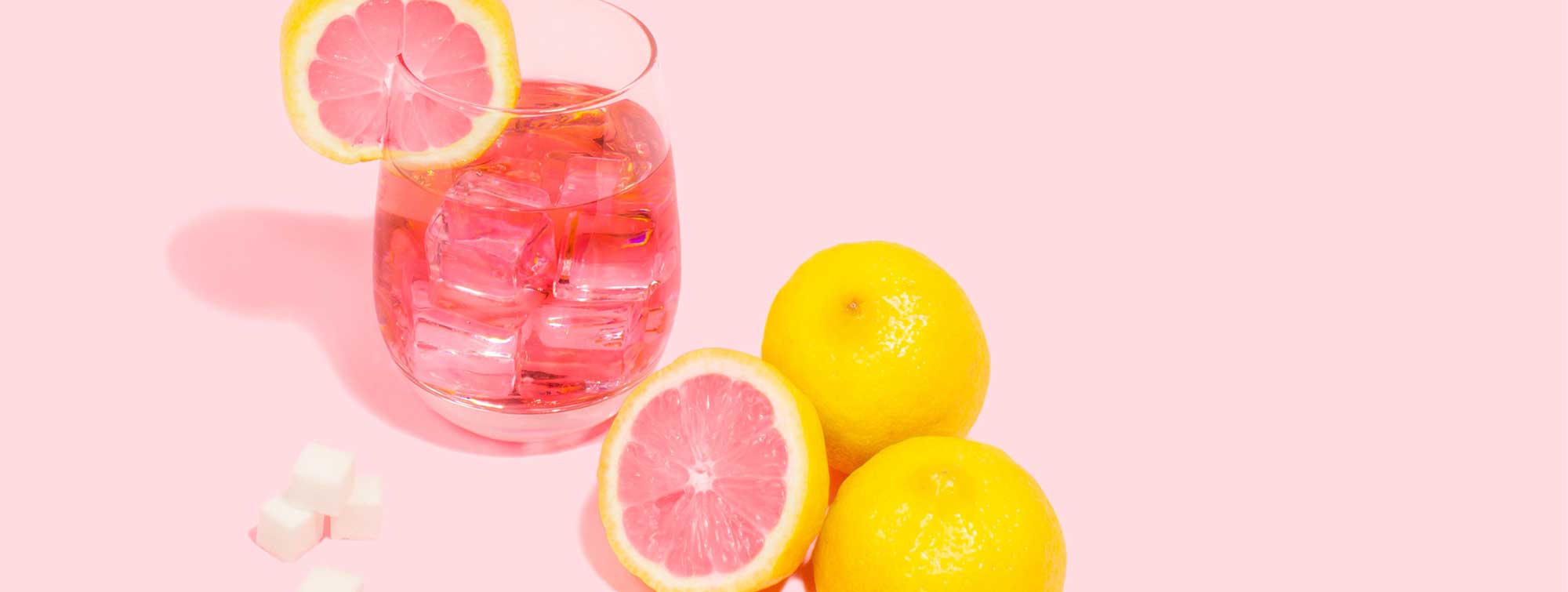 Glass with grapefruits and a hand