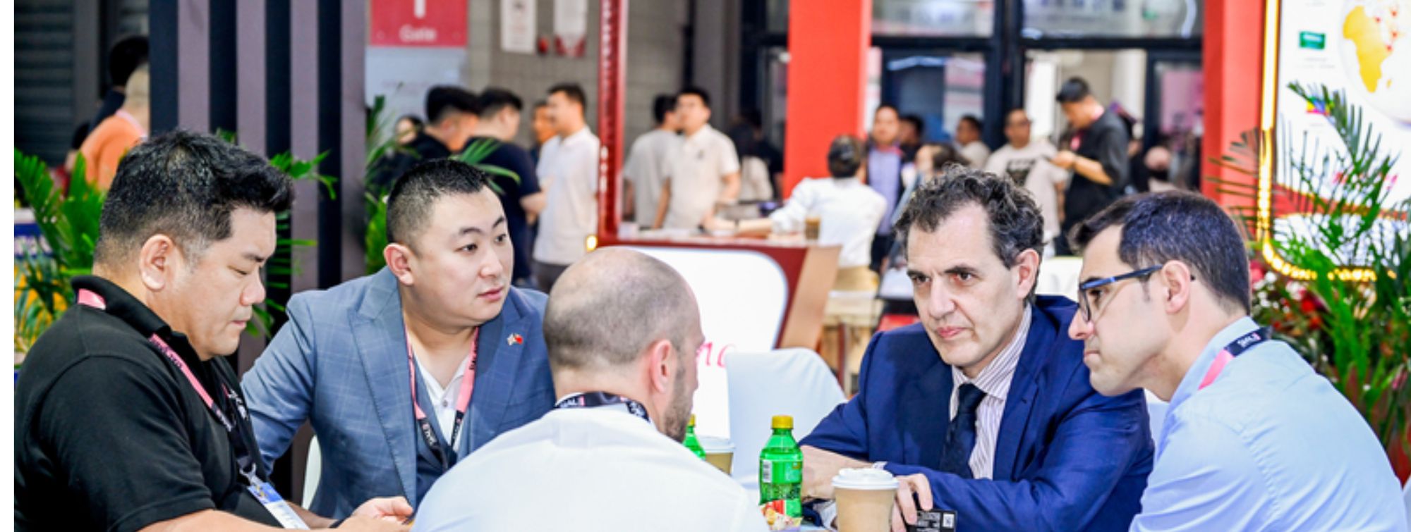 Meeting between buyers and exhibitors at a table during an international food trade show