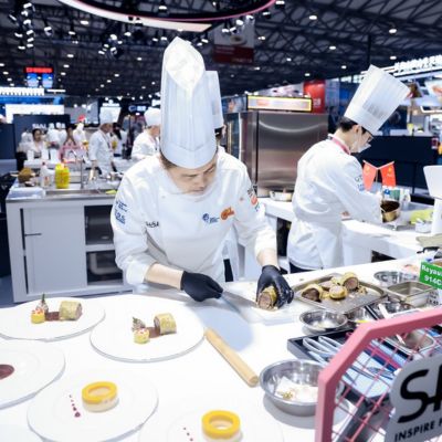 Professional chef creating gourmet recipes during a live culinary demonstration at SIAL Shanghai.