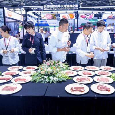 Chefs judging premium beef cuts during a steak competition at SIAL Shanghai food and beverage exhibition.