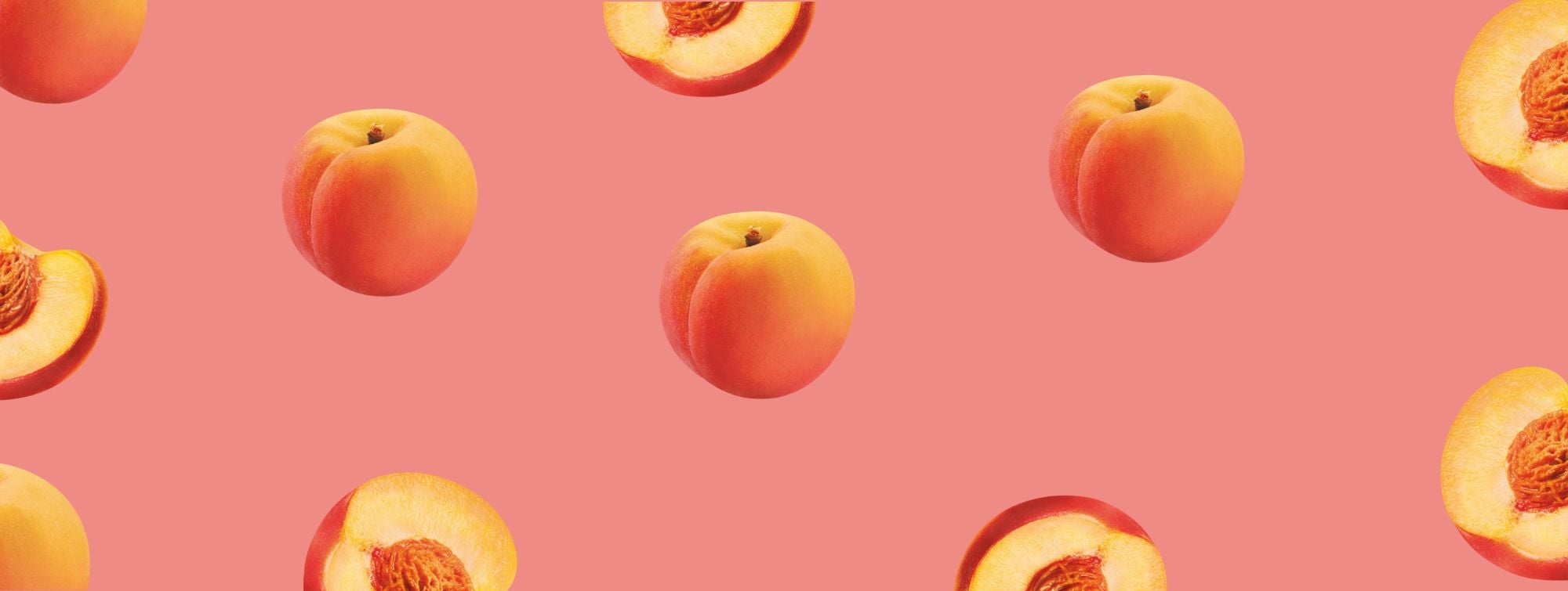 Seamless pattern of whole and sliced peaches on coral pink background