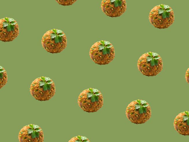 Falafel balls on green background